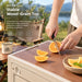 Camping storage box with wood-grain top for outdoor food preparation and serving