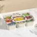 Plastic food storage container with multi compartments and clear snap-lock lid on kitchen countertop