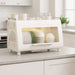 Compact dishrack with enclosed dish storage and transparent front door on kitchen countertop