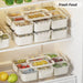 Stackable airtight food storage boxes organised neatly inside refrigerator shelves
