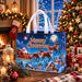 Blue Christmas tote bag with white handles featuring Santa Claus and reindeer sleigh design in a snowy Christmas village