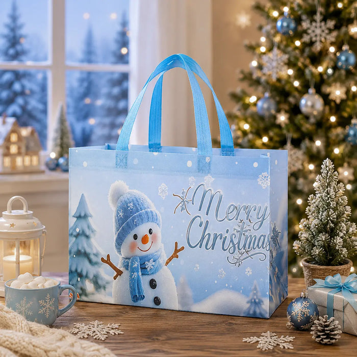 Light blue Christmas tote bag featuring a cheerful snowman with a blue hat and scarf, snowflakes, and Christmas trees.