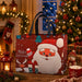 Red Christmas tote bag with black handles featuring a Santa Claus design, reindeer and gift box with festive snowflake details