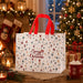 White Christmas tote bag with red handles and colourful Christmas icon pattern featuring snowflakes, gifts, candy canes, ornaments, Santa and Christmas trees