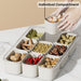 Removable inner compartment tray lifted from multi-grid storage organiser