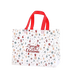 White Christmas tote bag with red handles and colourful Christmas icon pattern featuring snowflakes, gifts, candy canes, ornaments, Santa Claus, stars and Christmas trees