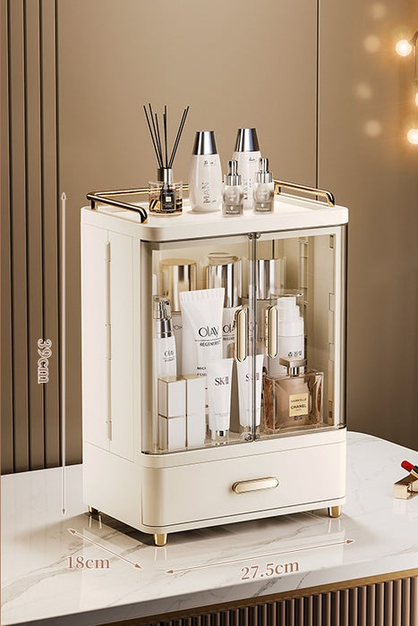Cream beige makeup drawer organiser with 1 drawer, transparent doors, gold-accented handles and top guardrail, showing dimensions of 27.5 cm wide, 18 cm deep and 39 cm high.