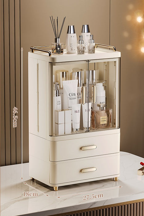 Cream beige makeup drawer organiser with 2 drawers, transparent double doors, gold-accented handles and top guardrail, showing dimensions of 27.5 cm wide, 18 cm deep and 46.5 cm high